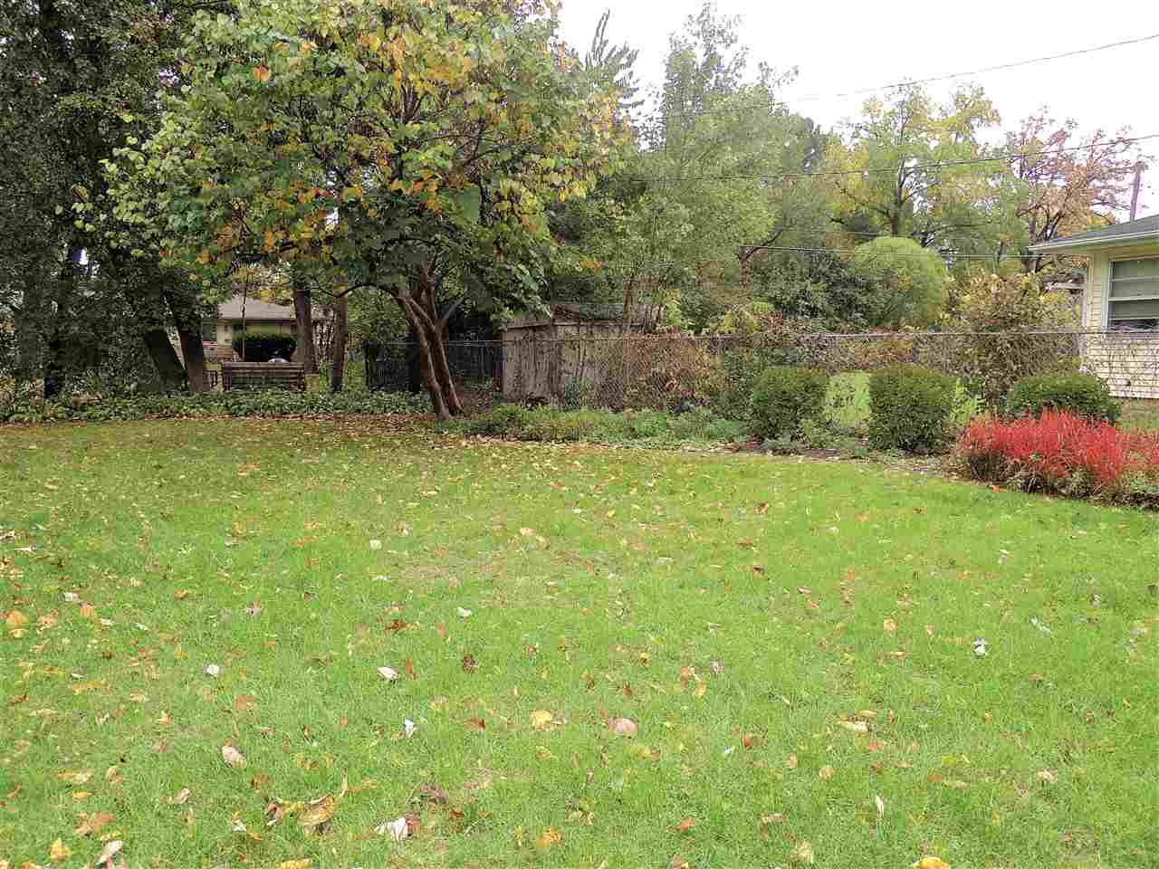 6233 Park Ridge Road Loves Park, IL 61111 - Photo 19 of 20 a backyard of a house with plants and large trees