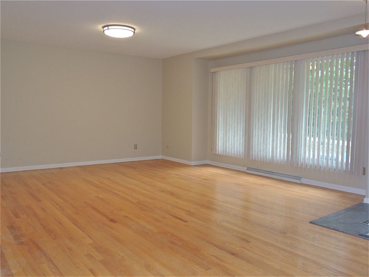 6233 Park Ridge Road Loves Park, IL 61111 - Photo 3 of 20 a view of an empty room with wooden floor and a window