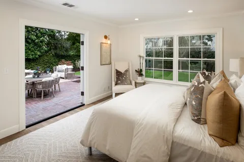 a spacious bedroom with a bed and a large window