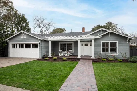 a front view of a house with a yard and porch