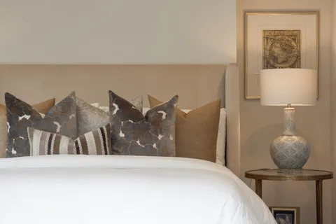 a bedroom with a bed and lamp