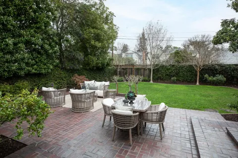 a view of a patio with garden and furniture