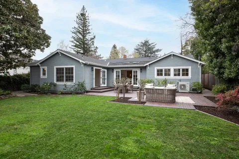 a front view of a house with a yard table and chairs