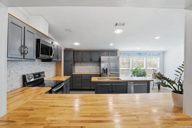 a large kitchen with stainless steel appliances kitchen island granite countertop a large kitchen counter top stainless steel appliances and cabinets