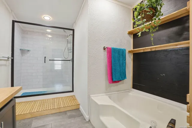 a bathroom with a bathtub and a shower
