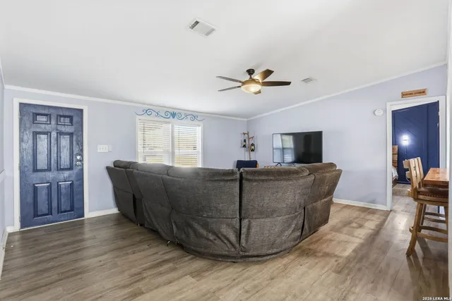 a living room with furniture and wooden floor