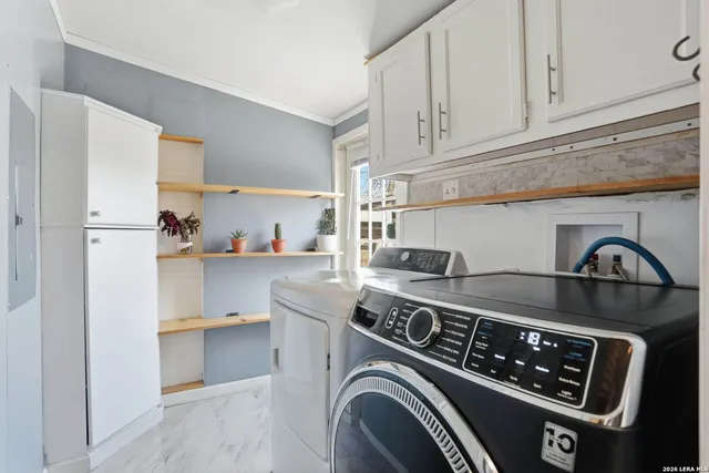 a utility room with sink dryer and washer