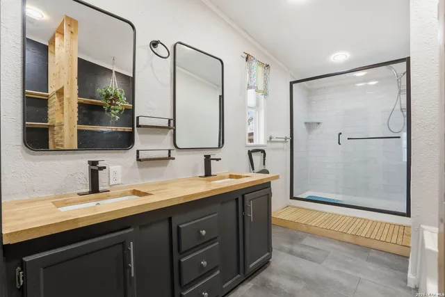 a bathroom with a double vanity sink mirror and double