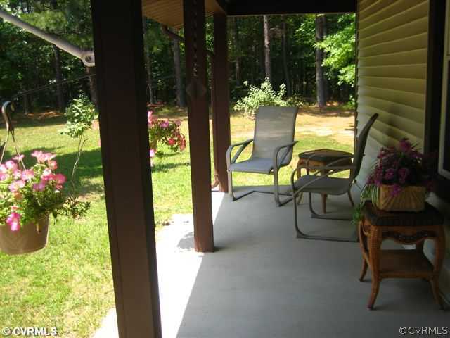 2347 Danieltown Road Goochland, VA 23063 - Photo 3 of 12 a view of a porch with chairs and potted plants
