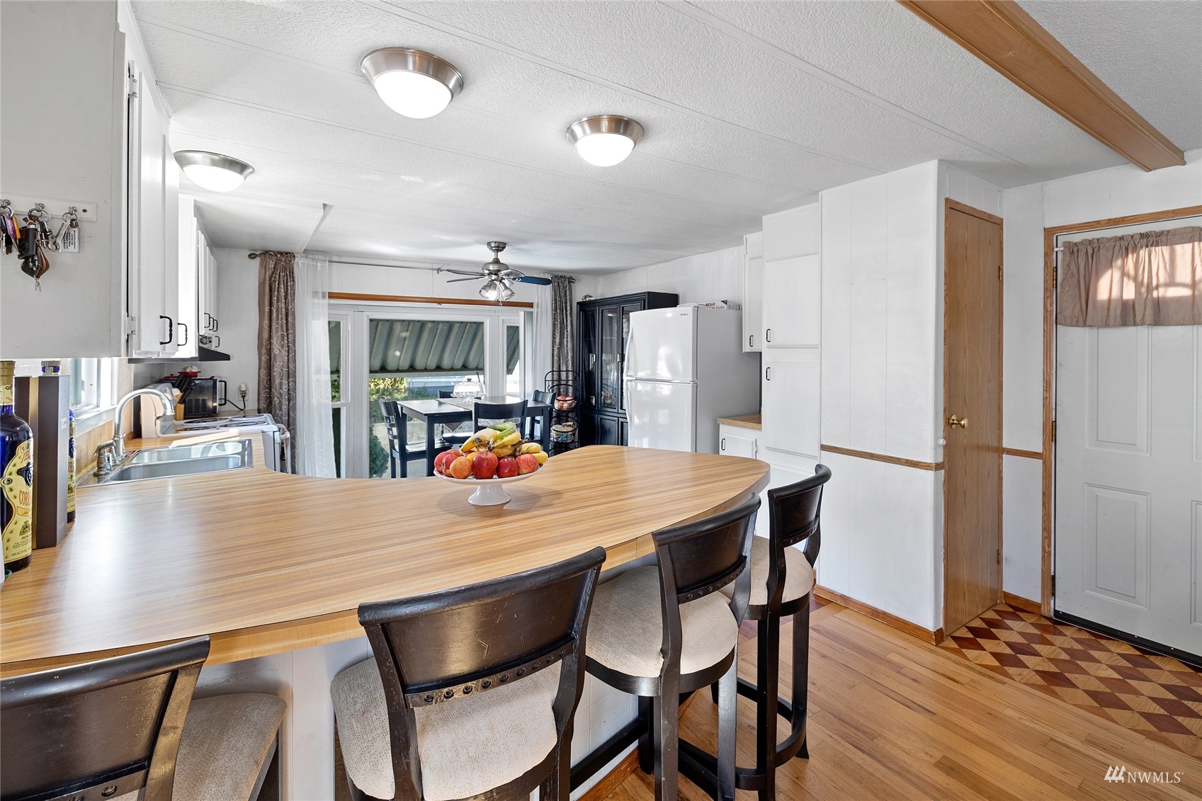 7311 Chambers Creek Road West, Unit 20 University Place, WA 98467 - Photo 17 of 23 a dining room with stainless steel appliances a table and chairs