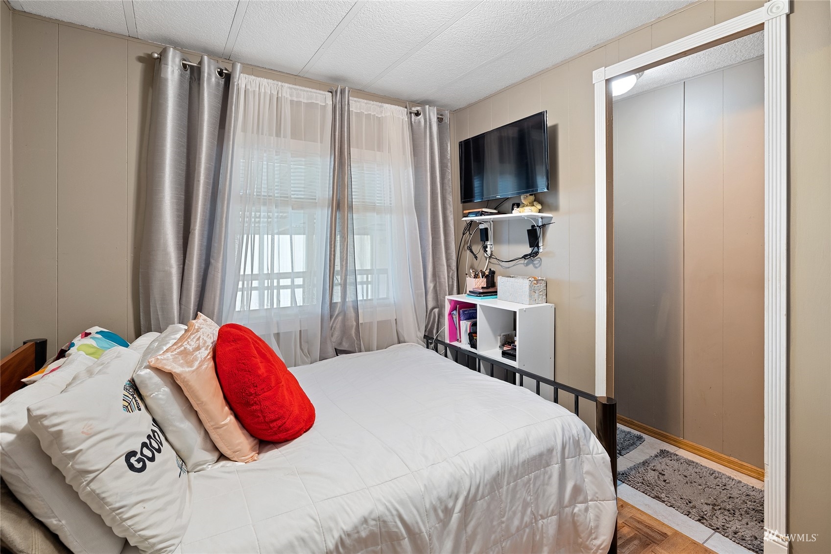 7311 Chambers Creek Road West, Unit 20 University Place, WA 98467 - Photo 18 of 23 a bedroom with a bed and a flat tv screen next to a window
