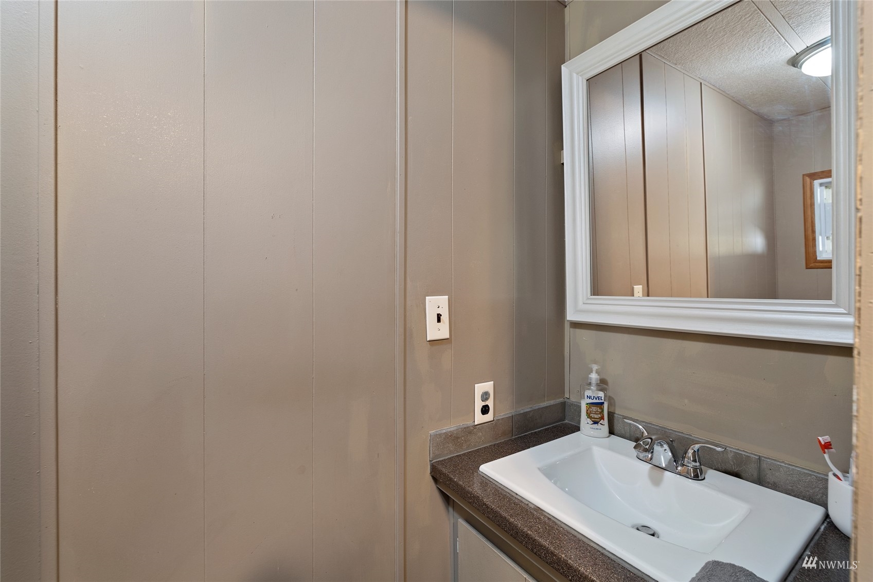 7311 Chambers Creek Road West, Unit 20 University Place, WA 98467 - Photo 19 of 23 a bathroom with a sink and a mirror