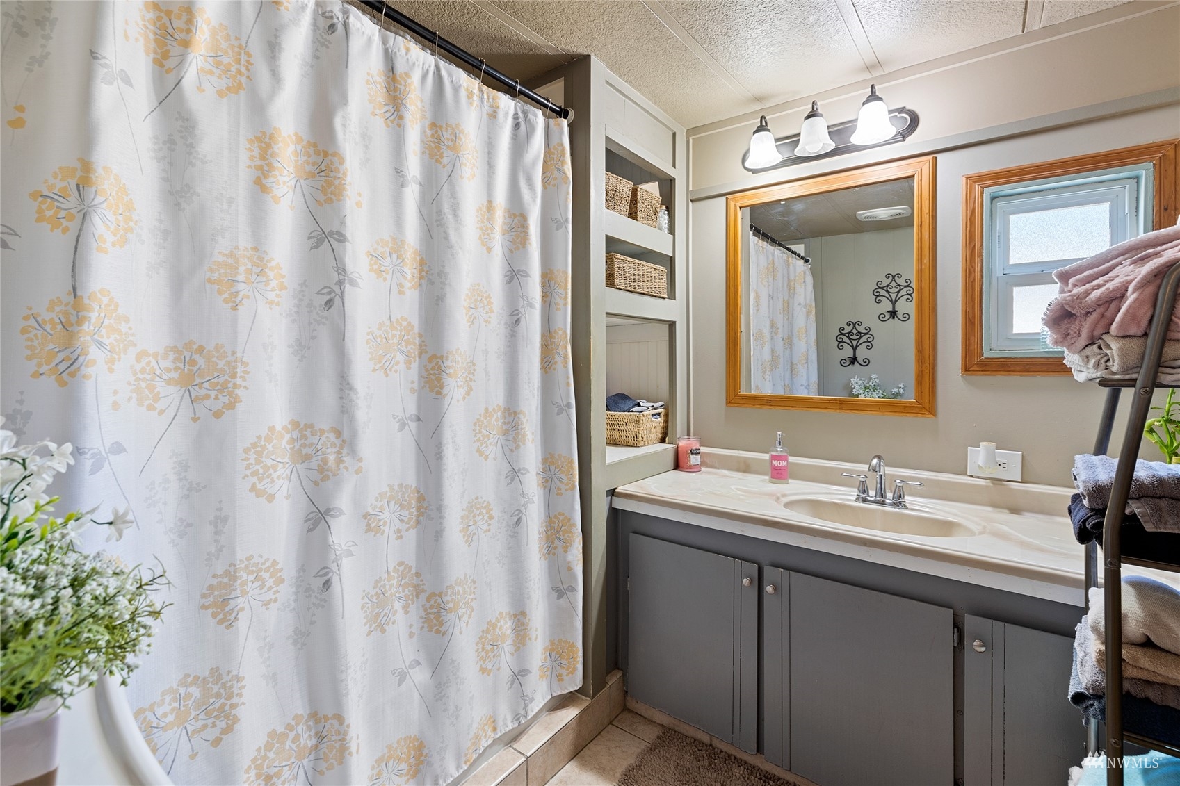 7311 Chambers Creek Road West, Unit 20 University Place, WA 98467 - Photo 22 of 23 a bathroom with a mirror a sink and a mirror
