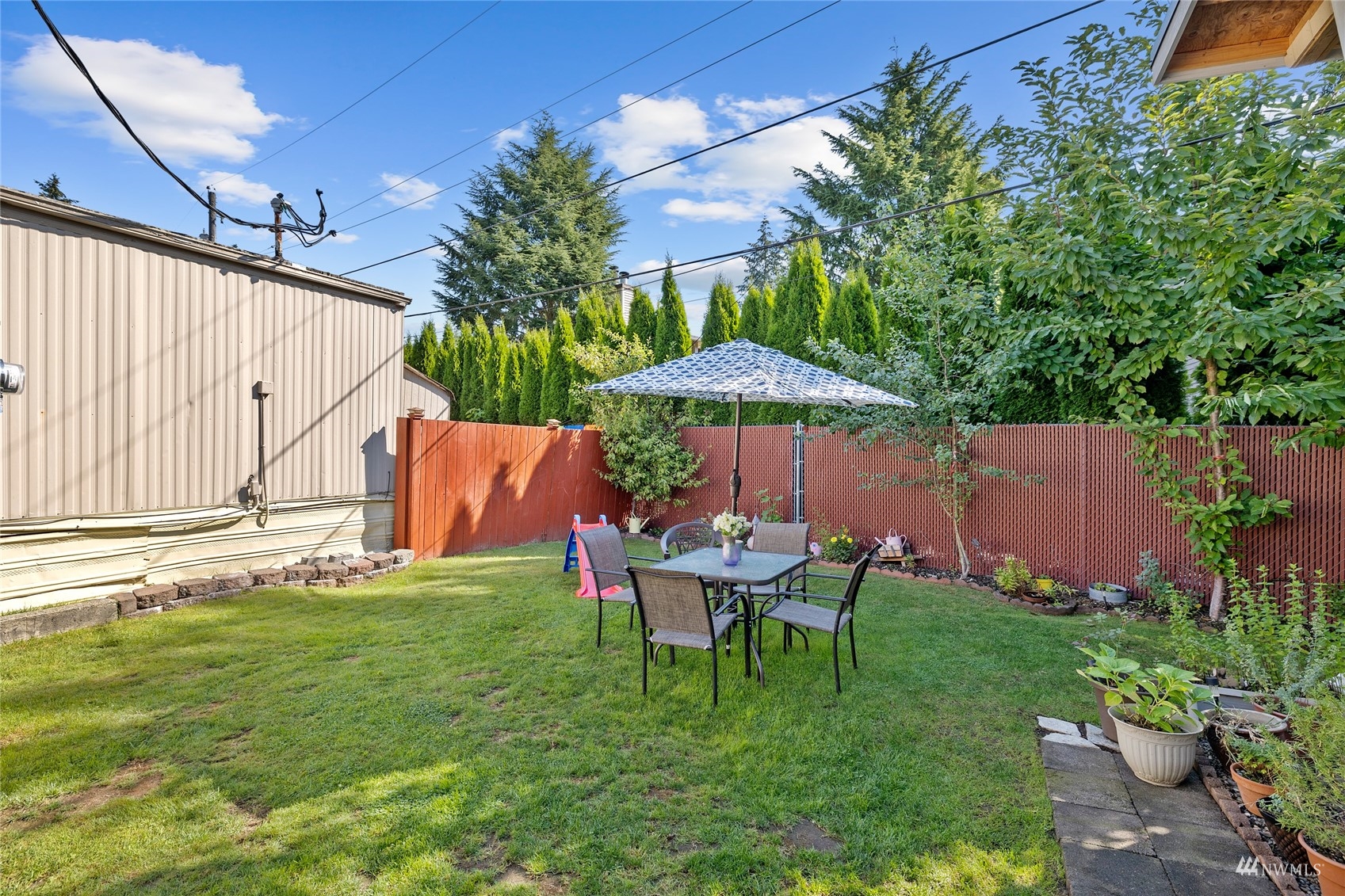 7311 Chambers Creek Road West, Unit 20 University Place, WA 98467 - Photo 6 of 23 a backyard of a house with table and chairs