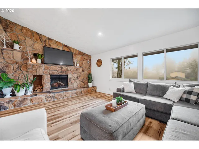 a living room with fireplace furniture and a flat screen tv