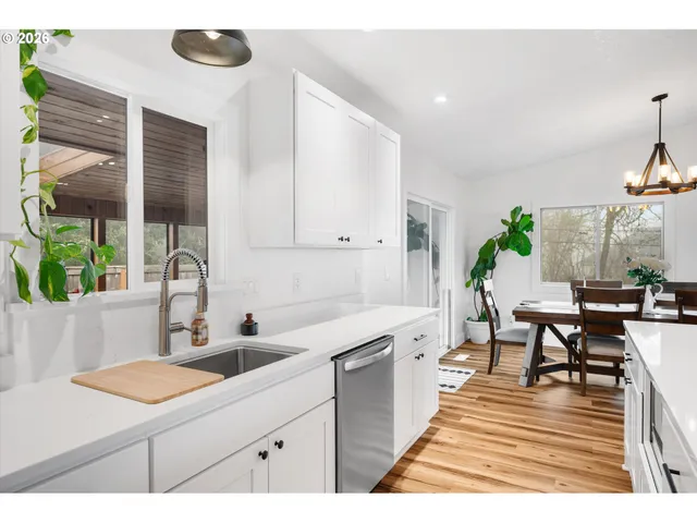a kitchen with a table chairs and a window
