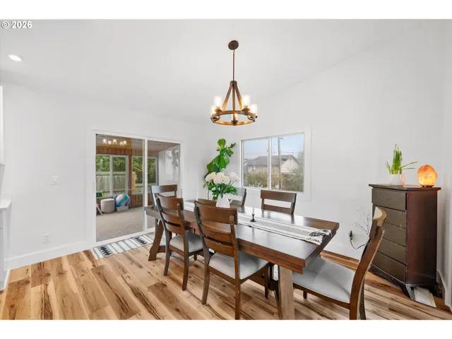 a dining room with furniture a window and a chandelier