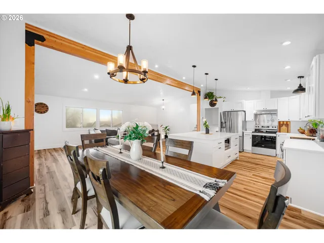 a living room with dining room and wooden floor