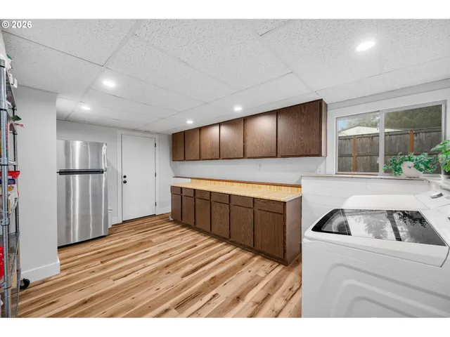 a kitchen with a refrigerator and a sink