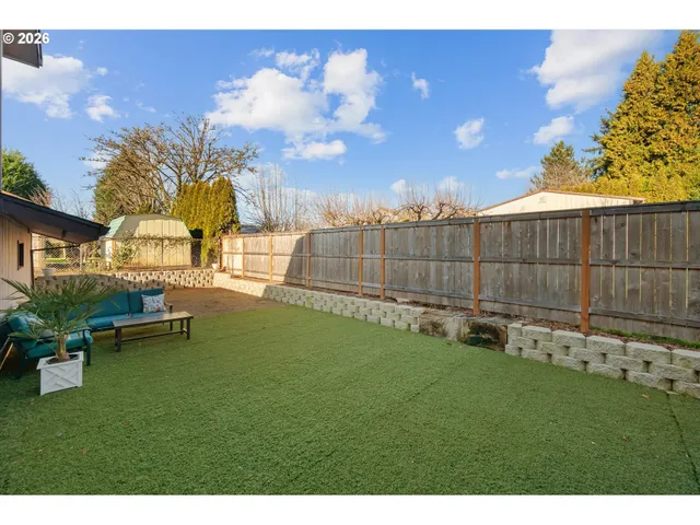a view of a backyard with swimming pool