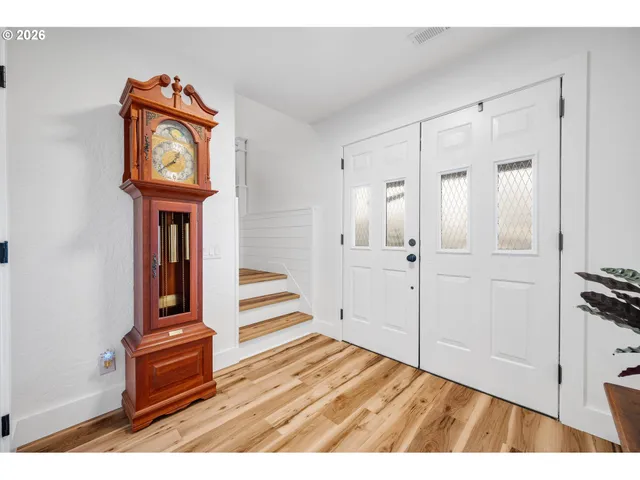 a view of an entryway with wooden floor