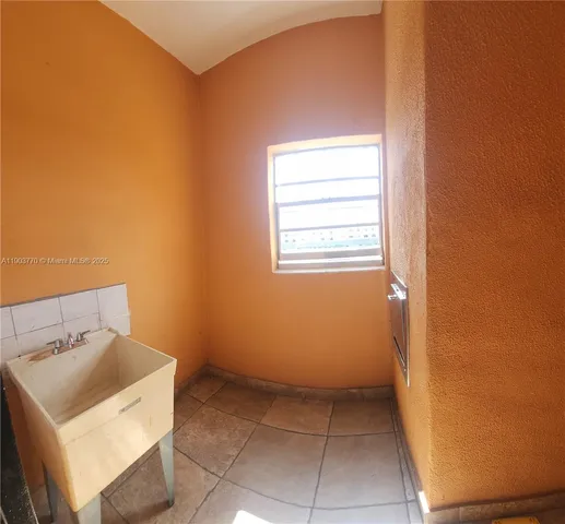 a utility room with a sink a washer and dryer