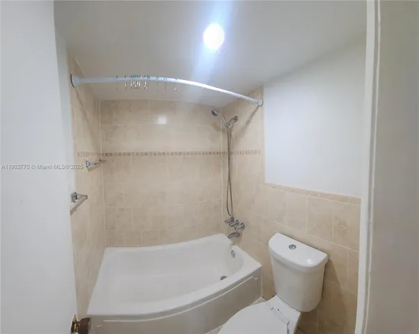 a bathroom with a toilet and a bathtub
