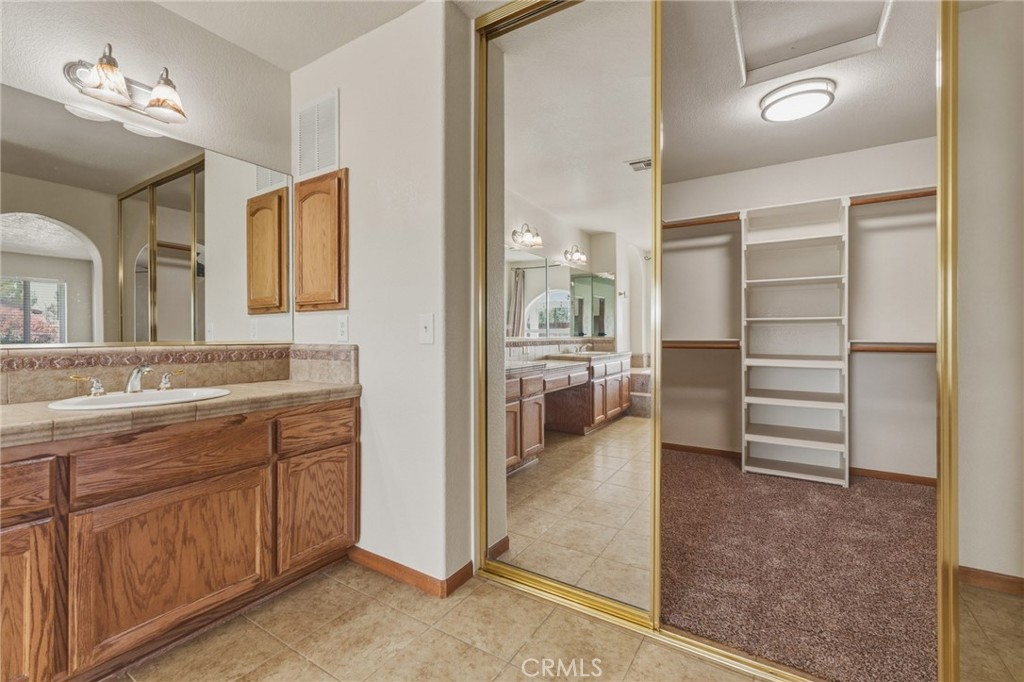 19501 Kinai Road Apple Valley, CA 92307 - Photo 31 of 49 a view of bathroom with a sink mirror and window