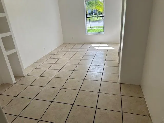 a view of an empty room and a window