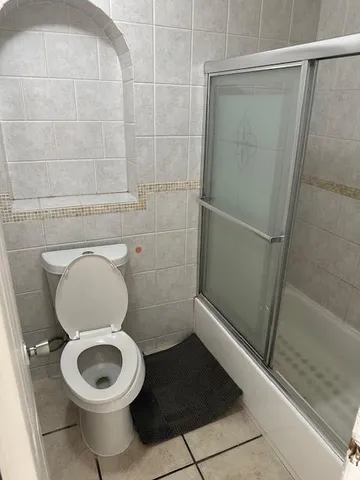 a bathroom with a toilet and a shower