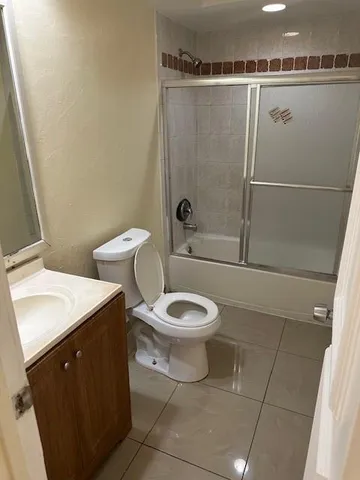 a bathroom with a toilet sink and shower
