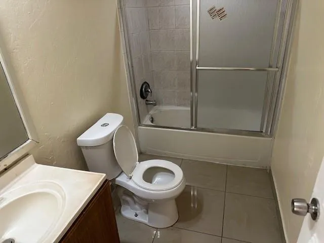 a white toilet sitting next to a bathroom sink