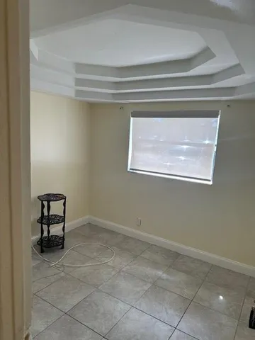 a view of a room that has a bench and a window