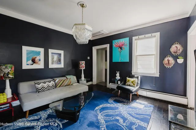 a view of a dining room with furniture window and front door
