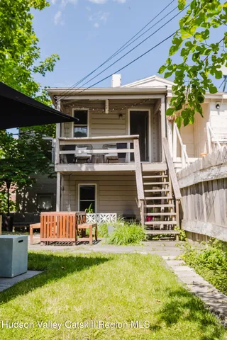 a view of a chair and tables in the balcony