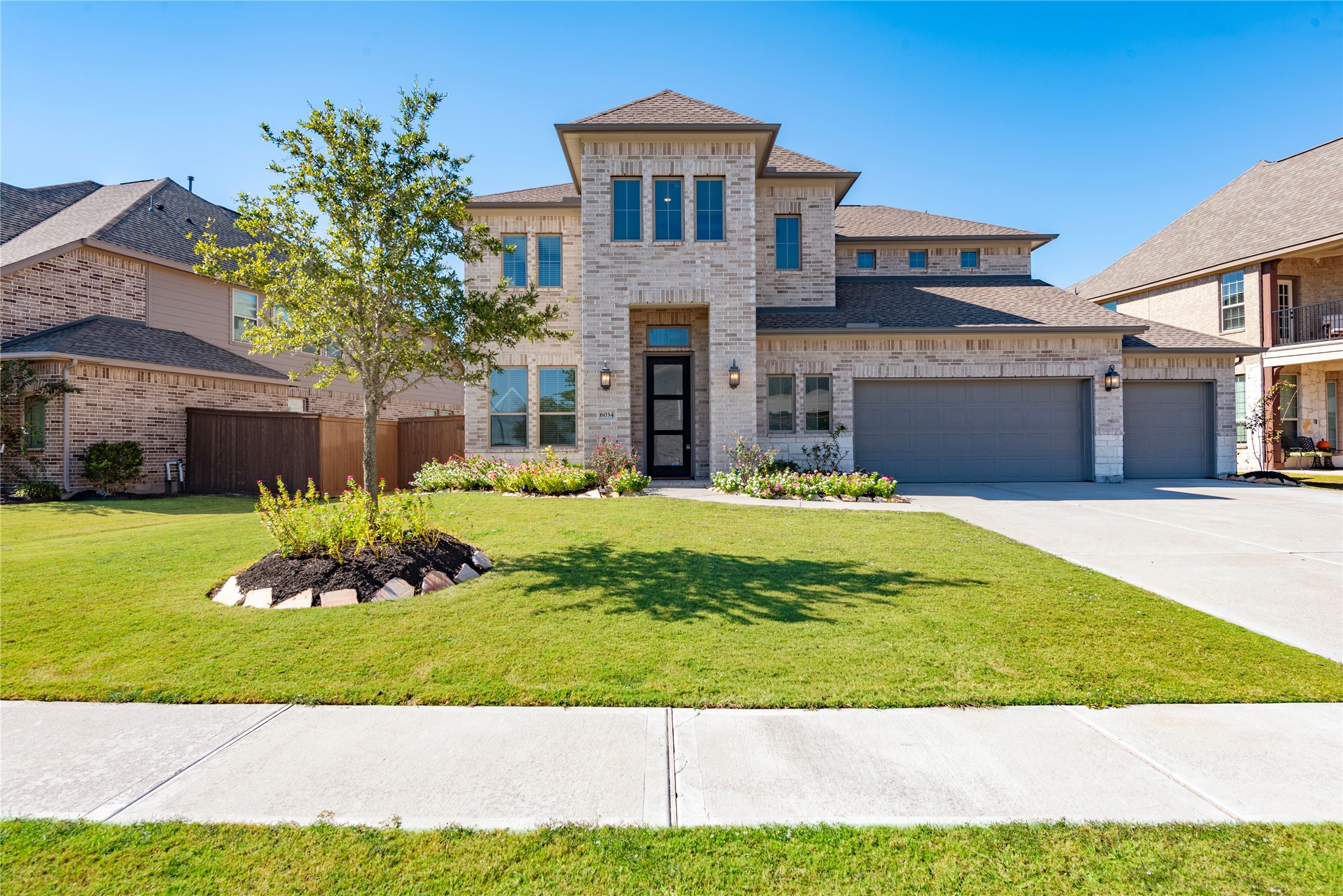 6034 Lake Bridge Lane Manvel, TX 77578 - Photo 1 of 33 a front view of a house with a yard