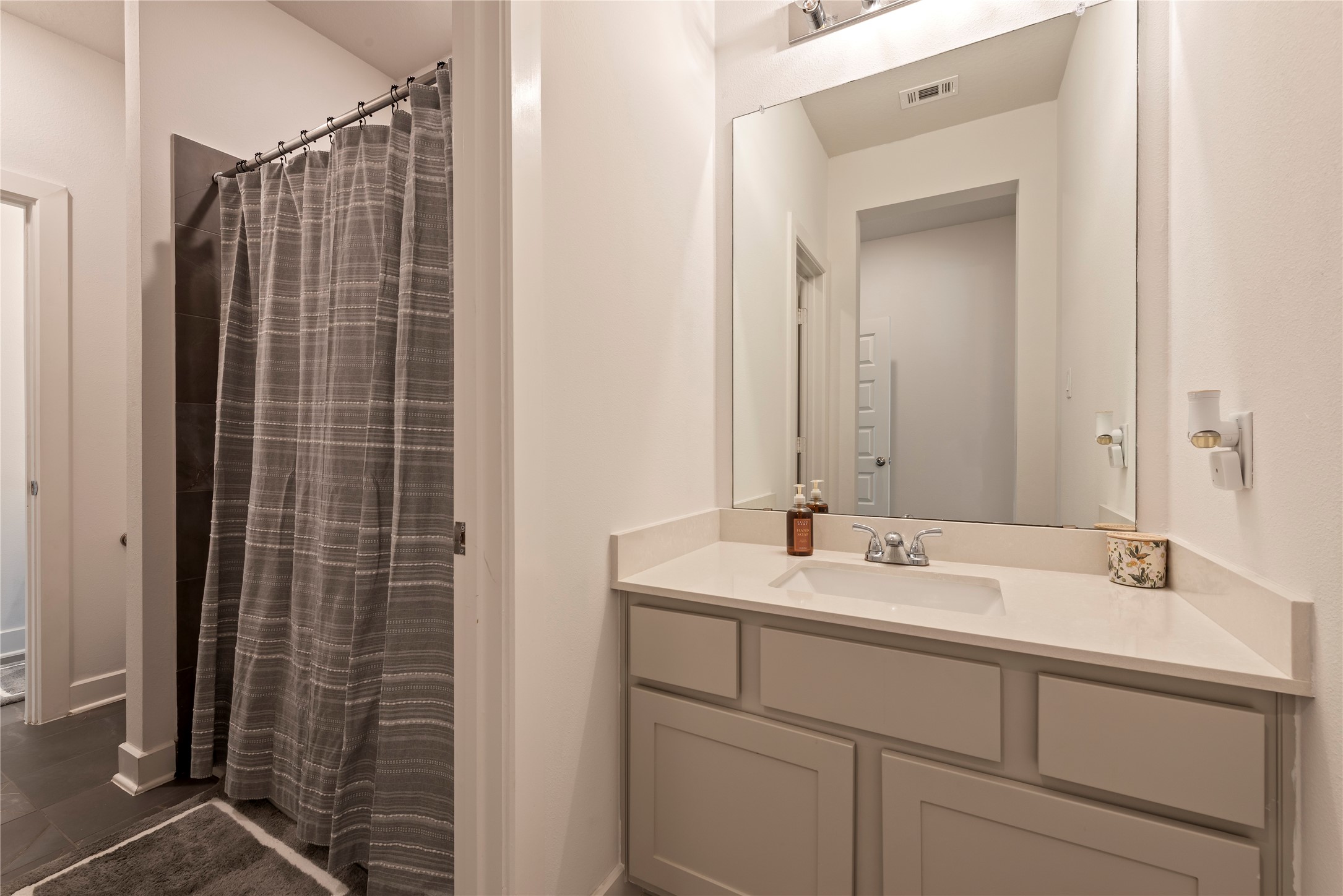 6034 Lake Bridge Lane Manvel, TX 77578 - Photo 21 of 33 a bathroom with a shower sink and mirror