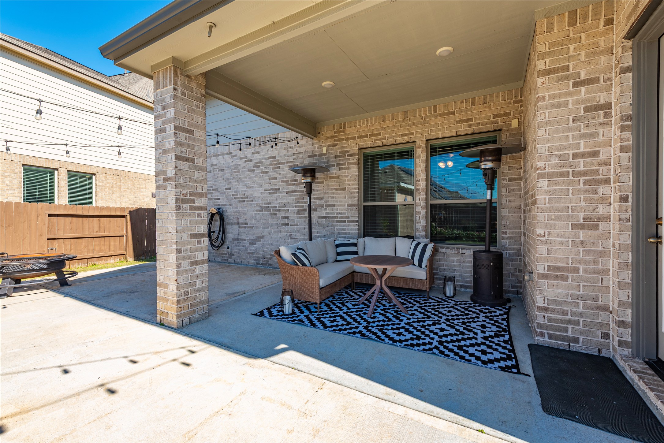 6034 Lake Bridge Lane Manvel, TX 77578 - Photo 23 of 33 a outdoor space with patio furniture and a fireplace