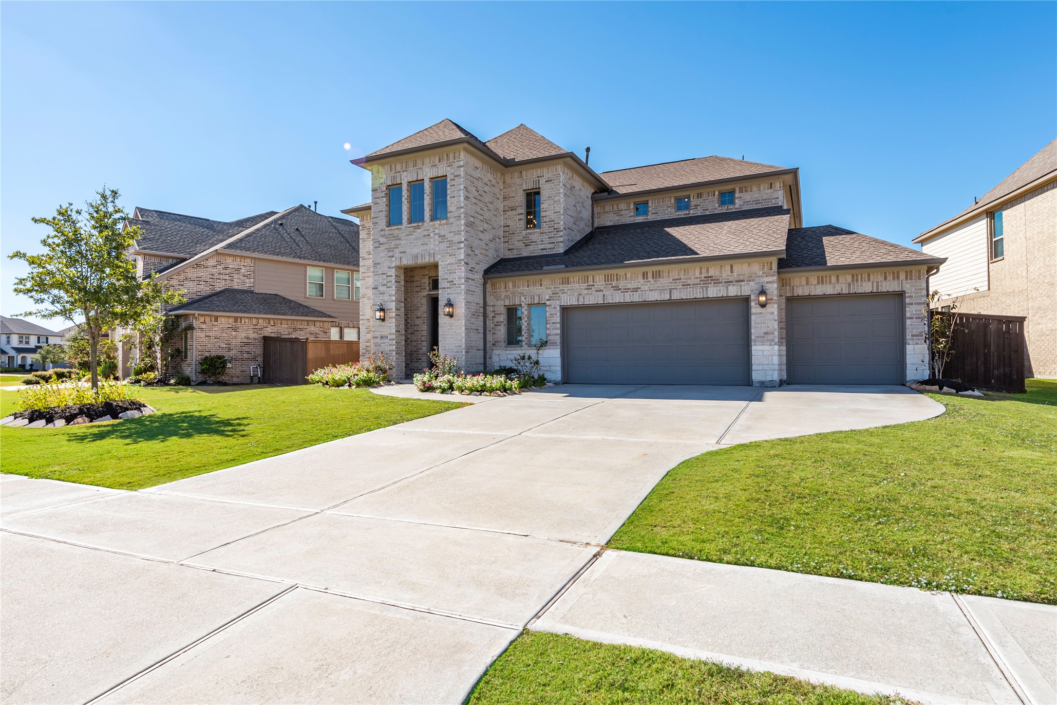 6034 Lake Bridge Lane Manvel, TX 77578 - Photo 3 of 33 a front view of a house with a yard and garage