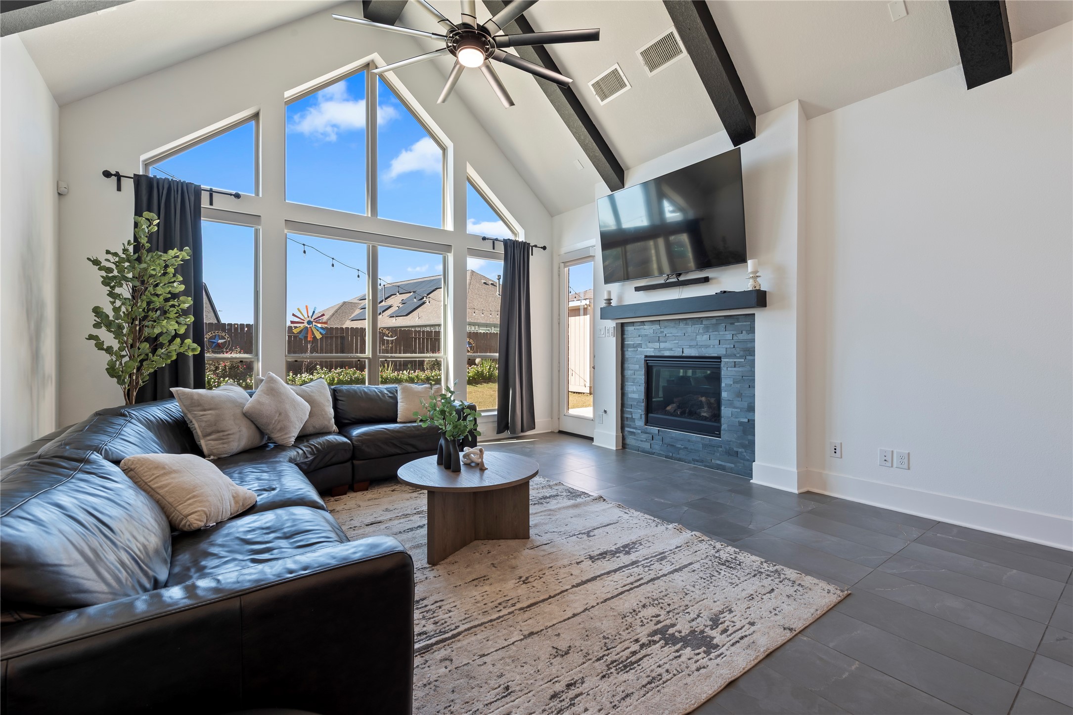 6034 Lake Bridge Lane Manvel, TX 77578 - Photo 7 of 33 a living room with furniture fireplace and a floor to ceiling window