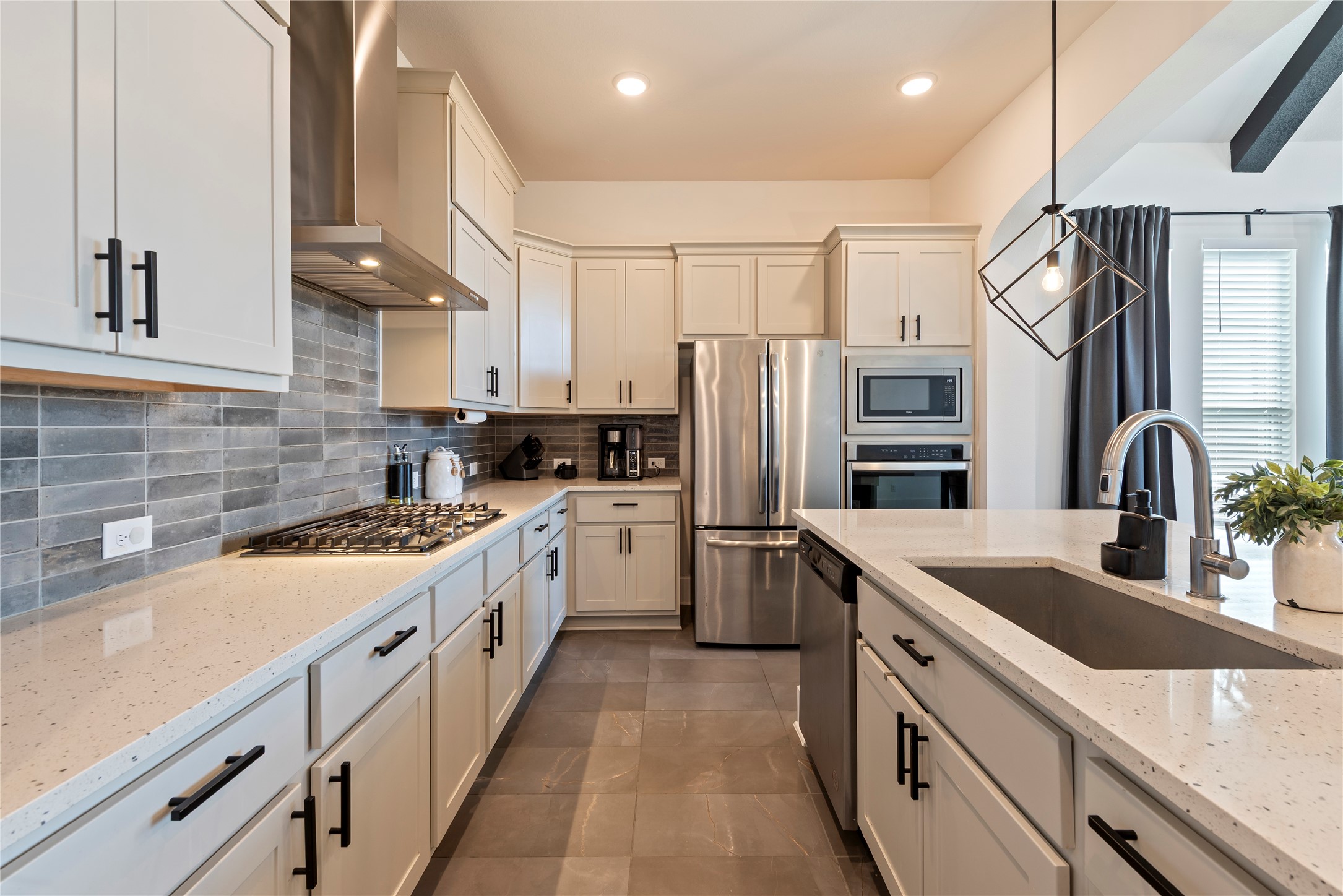 6034 Lake Bridge Lane Manvel, TX 77578 - Photo 9 of 33 a kitchen with refrigerator a sink and cabinets