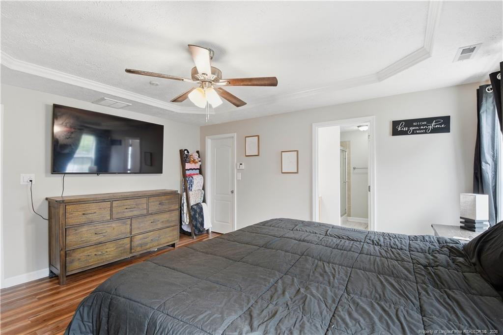 212 Lennox Loop Raeford, NC 28376 - Photo 26 of 47 a bedroom with a bed and a flat screen tv