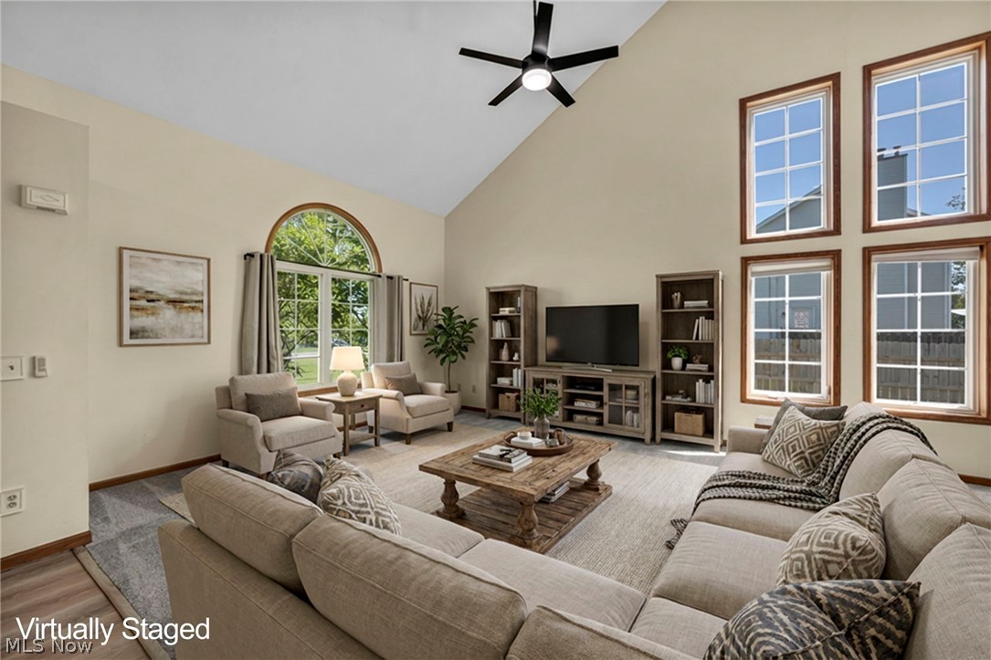 9842 Johnnycake Ridge Road Mentor, OH 44060 - Photo 7 of 40 Spacious living area featuring vaulted ceilings, a ceiling fan, and abundant natural light from multiple windows
