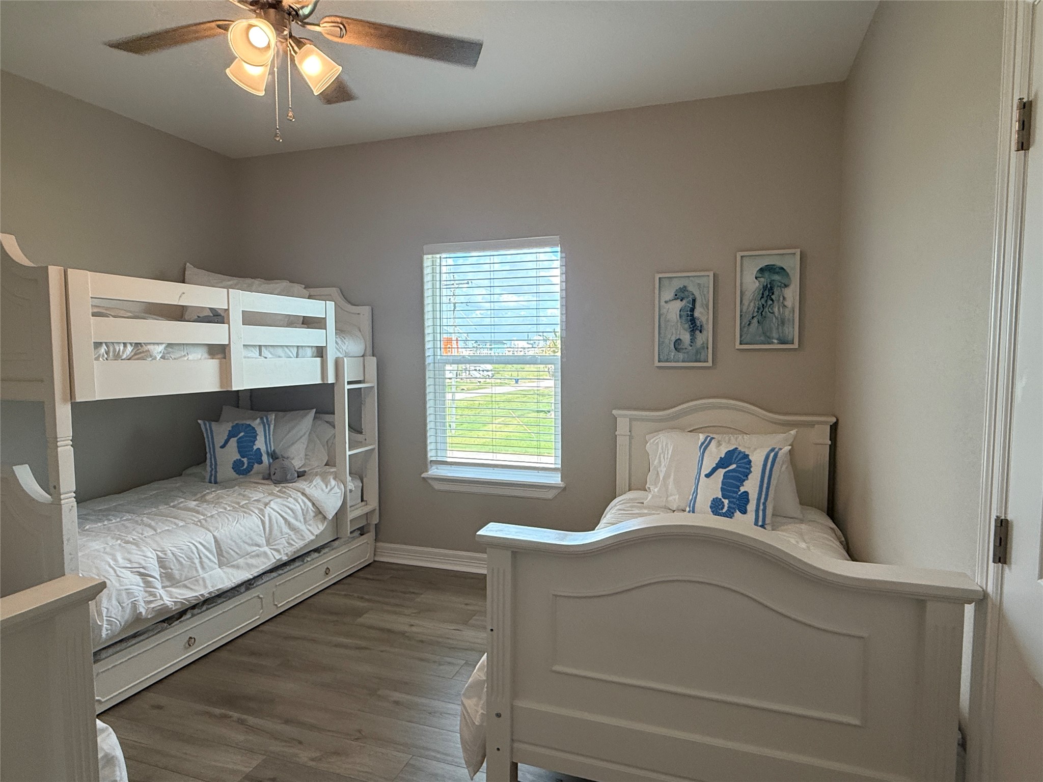 528 Thunder Road Surfside Beach, TX 77541 - Photo 16 of 22 a bedroom with a bed and a chandelier
