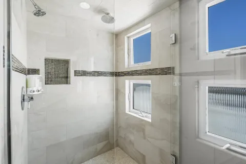 a bedroom with a large bed and a chandelier