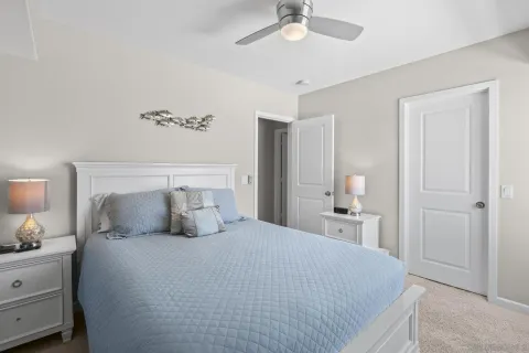a kitchen with a refrigerator and white cabinets