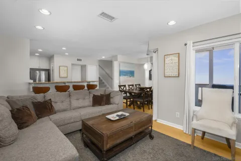 a living room with furniture and kitchen view