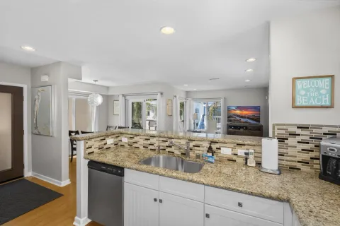 a kitchen with granite countertop a sink stove and refrigerator