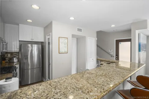 a view of a dining room with furniture a chandelier and wooden floor