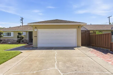 a view of a house with a backyard and a garage